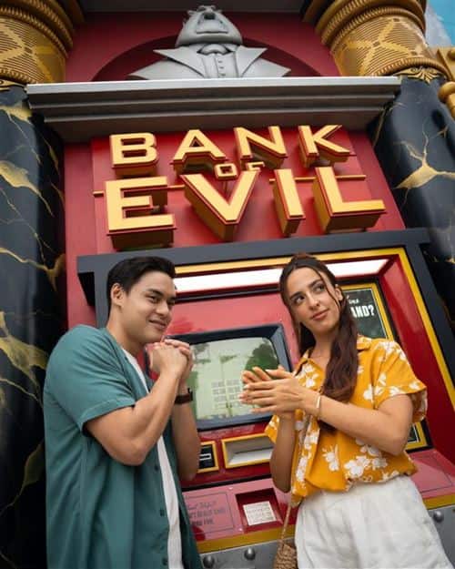 Guests posing outside the Bank of Evil in Illumination's Minion Land at Universal Studios Singapore