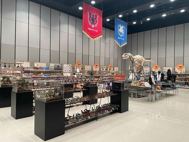 Browse a selection of exclusive dinosaur merchandise and collectibles from Japan available for purchase at the DINOSAUR ODYSSEY Activation Area.