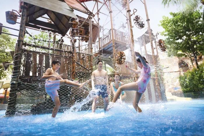 Family playing at the Big Bucket Treehouse at Adventure Cove Waterpark