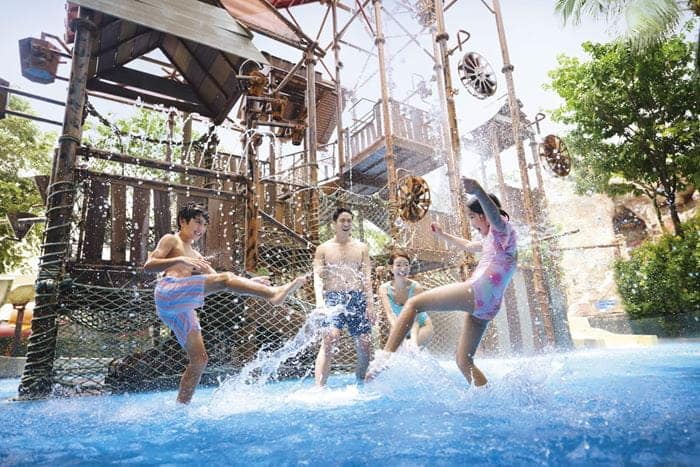 Family playing at the Big Bucket Treehouse at Adventure Cove Waterpark