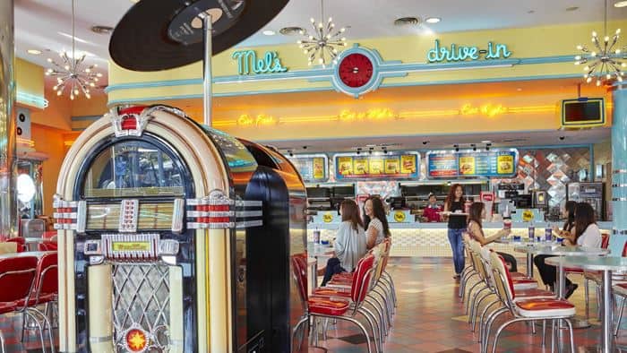 People sitting at Mel’s Drive-In at USS