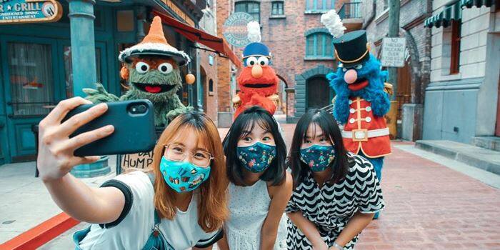 Universal Studios Singapore guests taking a selfie with Sesame Street characters