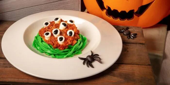Halloween-themed green spinach tagliatelle with beef Bolognese sauce